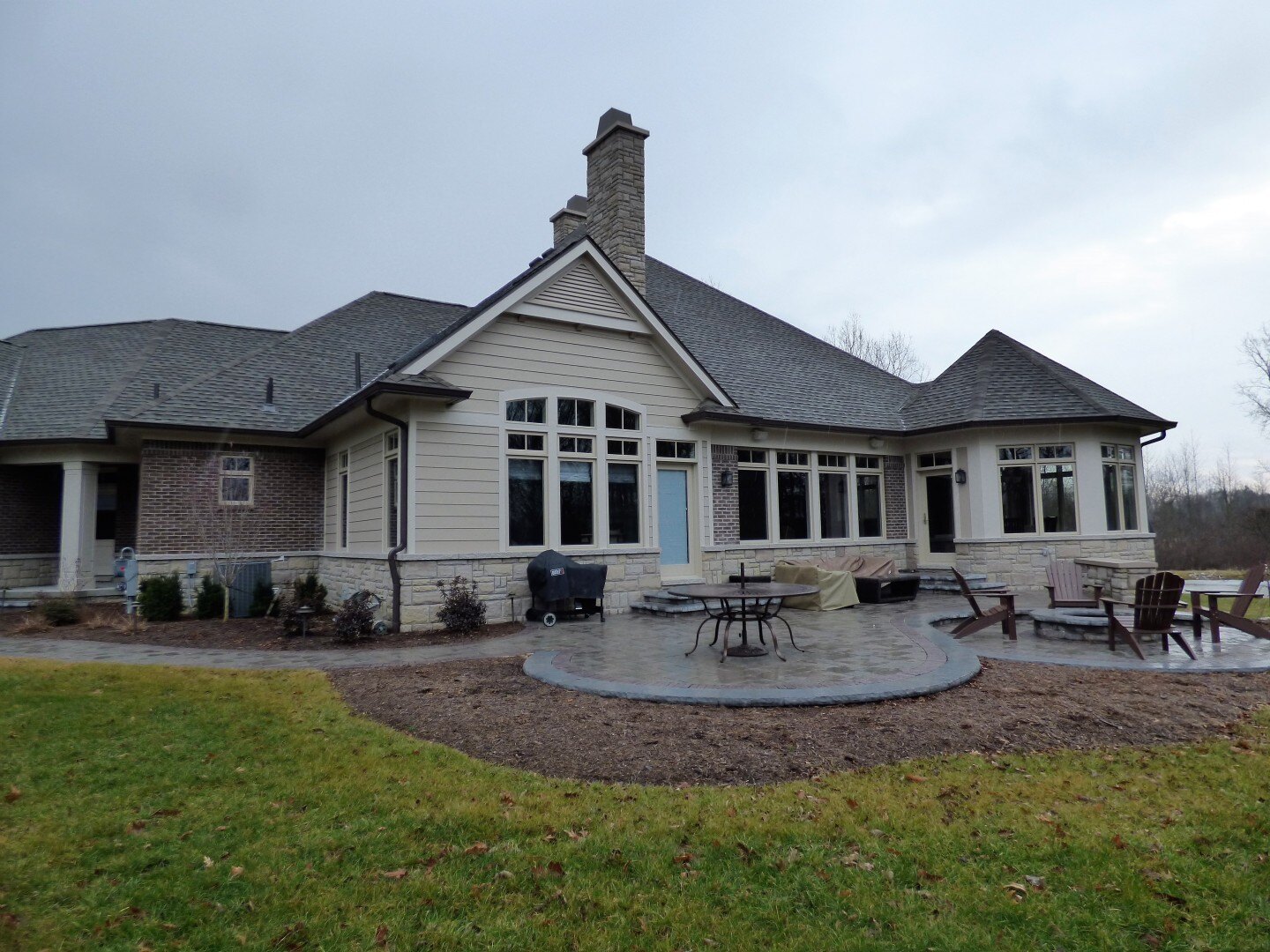 custom home in madison heights mi wit backyard patio seating areas and fire pit